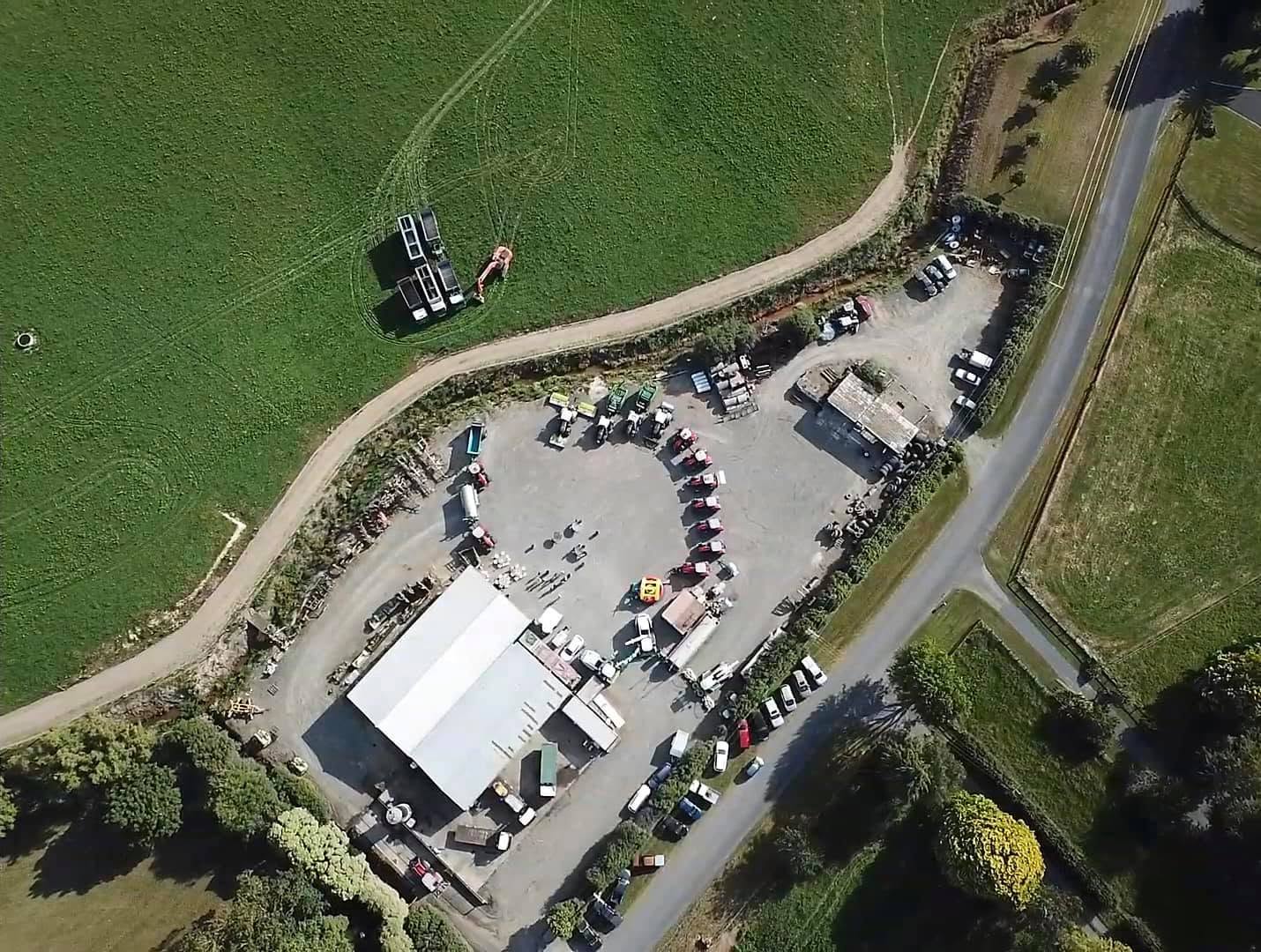 Aerial view of the Walling Contracting yard with tractors, trucks and gear parked around the shed and hardstand